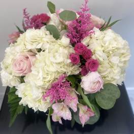 Bouquet of white hydrangeas, pink roses, and magenta filler flowers