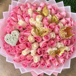Large bouquet of pink and cream roses with gold butterfly decorations