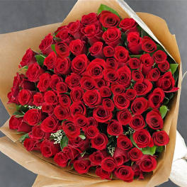 Large bouquet of red roses wrapped in brown paper
