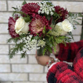 Bouquet of burgundy and white flowers with greenery