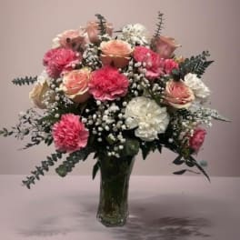 Pink and white flower bouquet in a clear glass vase