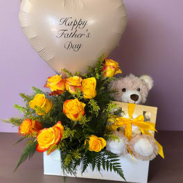 Yellow roses with a heart-shaped Father’s Day balloon and teddy bear gift box