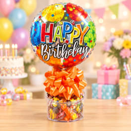 Birthday balloon with candy in a clear container and orange bow
