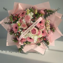 Pink mixed bouquet with roses, gerbera daisies, and a birthday ribbon