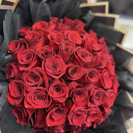 Bouquet of red roses wrapped in black paper