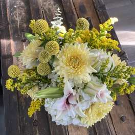 Bouquet of pale yellow and white flowers with pink lilies