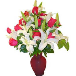 12 Red Roses and Lilies arranged in a vase.