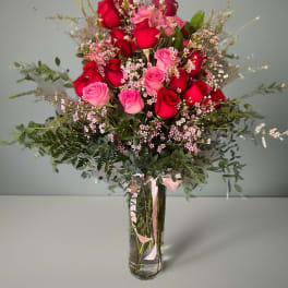 Bouquet of red and pink roses in a clear glass vase