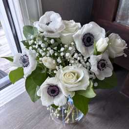 White roses and anemones in a glass vase