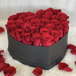 Heart-shaped box filled with red roses