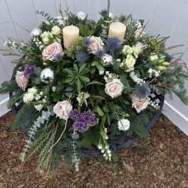 Floral wreath with roses, thistles, and candles