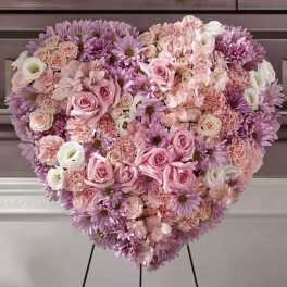 Heart-shaped floral arrangement with pink and lavender flowers