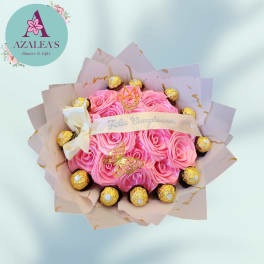 Pink rose bouquet with Ferrero Rocher chocolates and a cream ribbon