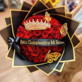Red rose bouquet with a jeweled crown and black-and-gold wrapping