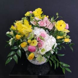Bouquet of yellow and pink flowers in a white vase
