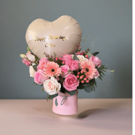 Pink rose bouquet with gerbera daisies and a heart balloon in a pink box