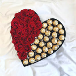 Heart-shaped box with red roses and gold-wrapped chocolates