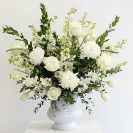 White floral arrangement in a white vase