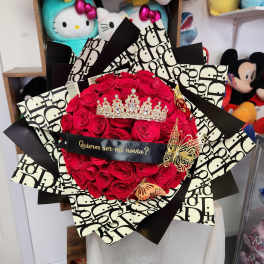 Bouquet of red roses with a jeweled crown and black patterned wrap