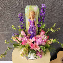 Princess doll in a pink and purple flower arrangement