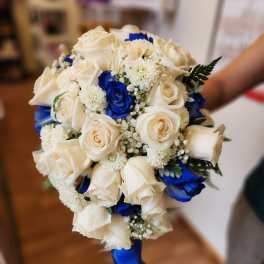 Bouquet of white and blue roses with small white filler flowers