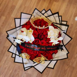 Bouquet of red roses with white orchids and a gold crown