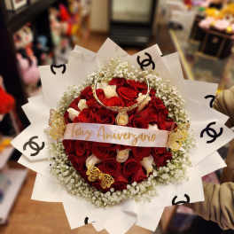 Bouquet of red and white roses with baby's breath and decorative wrap