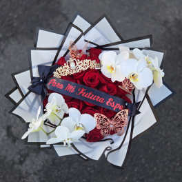 Bouquet of red roses and white orchids with decorative butterflies and ribbon