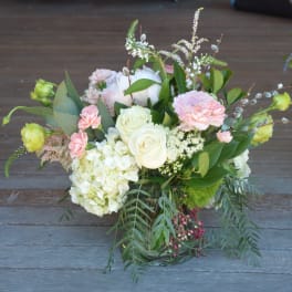 Bouquet of white and pale pink flowers in a glass vase