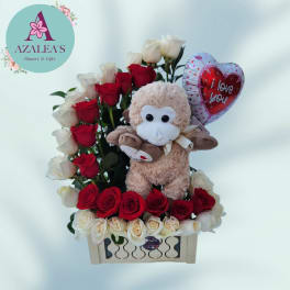 Red and white roses with a plush monkey and heart balloon in a box