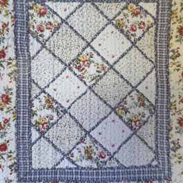 Floral patchwork quilt with blue plaid borders
