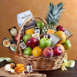 Large gourmet fruit and snack basket with apples, citrus, pineapple, cheese, and cookies