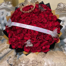 Large bouquet of red roses with a tiara and butterfly decorations