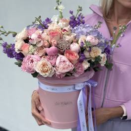 Large pastel bouquet in a pink hatbox with a lavender ribbon