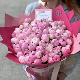 Large bouquet of pink peonies wrapped in bright pink paper