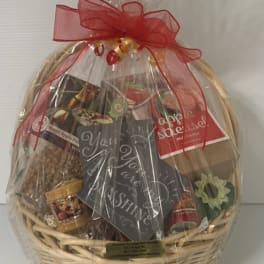 Gift basket with assorted packaged snacks and a red ribbon bow