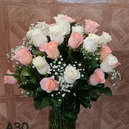 Bouquet of pink and white roses in a clear glass vase