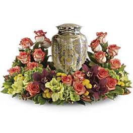 Floral arrangement with pink roses around a decorative urn