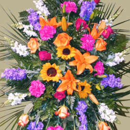 Large standing spray with orange lilies, roses, and purple flowers