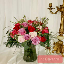 Bouquet of pink and red roses in a glass vase