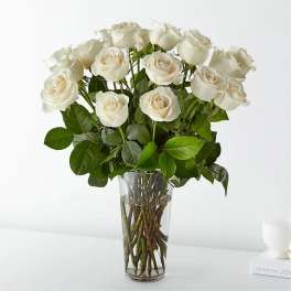 White roses arranged in a clear glass vase