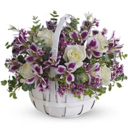 White roses and purple alstroemeria in a white basket