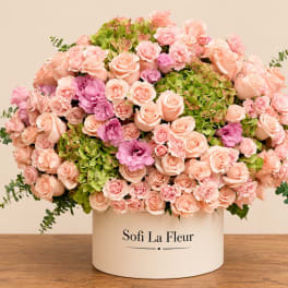 Large pink and peach rose arrangement in a white hat box