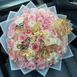 Bouquet of pink and white roses with gold butterfly decorations