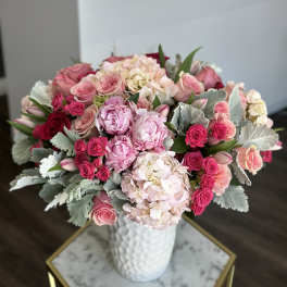 Pink roses and hydrangeas in a white vase