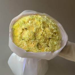 Bouquet of pale yellow carnations wrapped in white paper