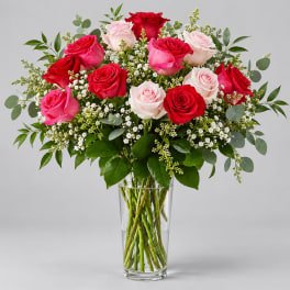Bouquet of red and pink roses in a clear glass vase