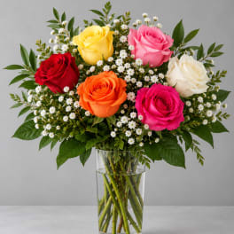 Bouquet of multicolored roses in a clear glass vase
