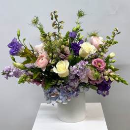 Mixed pastel bouquet in a white cylindrical vase
