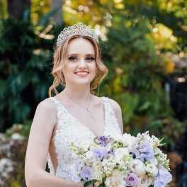 Bride holding a pastel bouquet and wearing a jeweled tiara